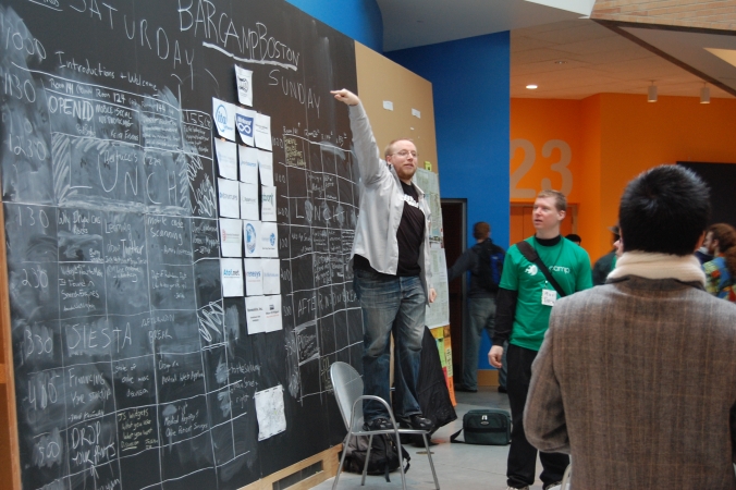 Taking charge in front of the BarCampBoston2 daily schedule.
